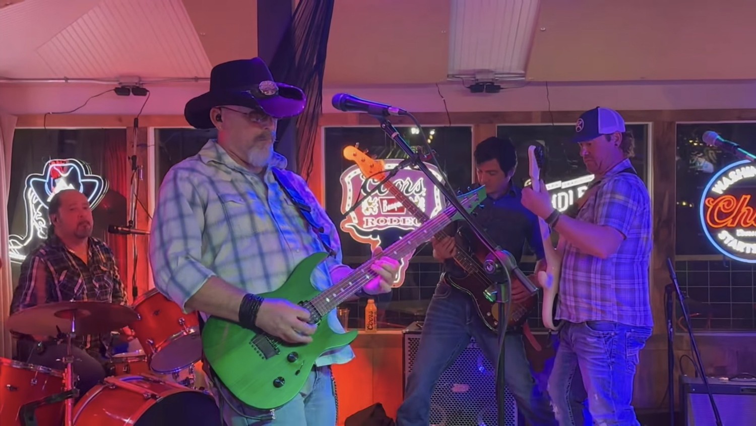 Back Roads playing together under warm red and purple club lights